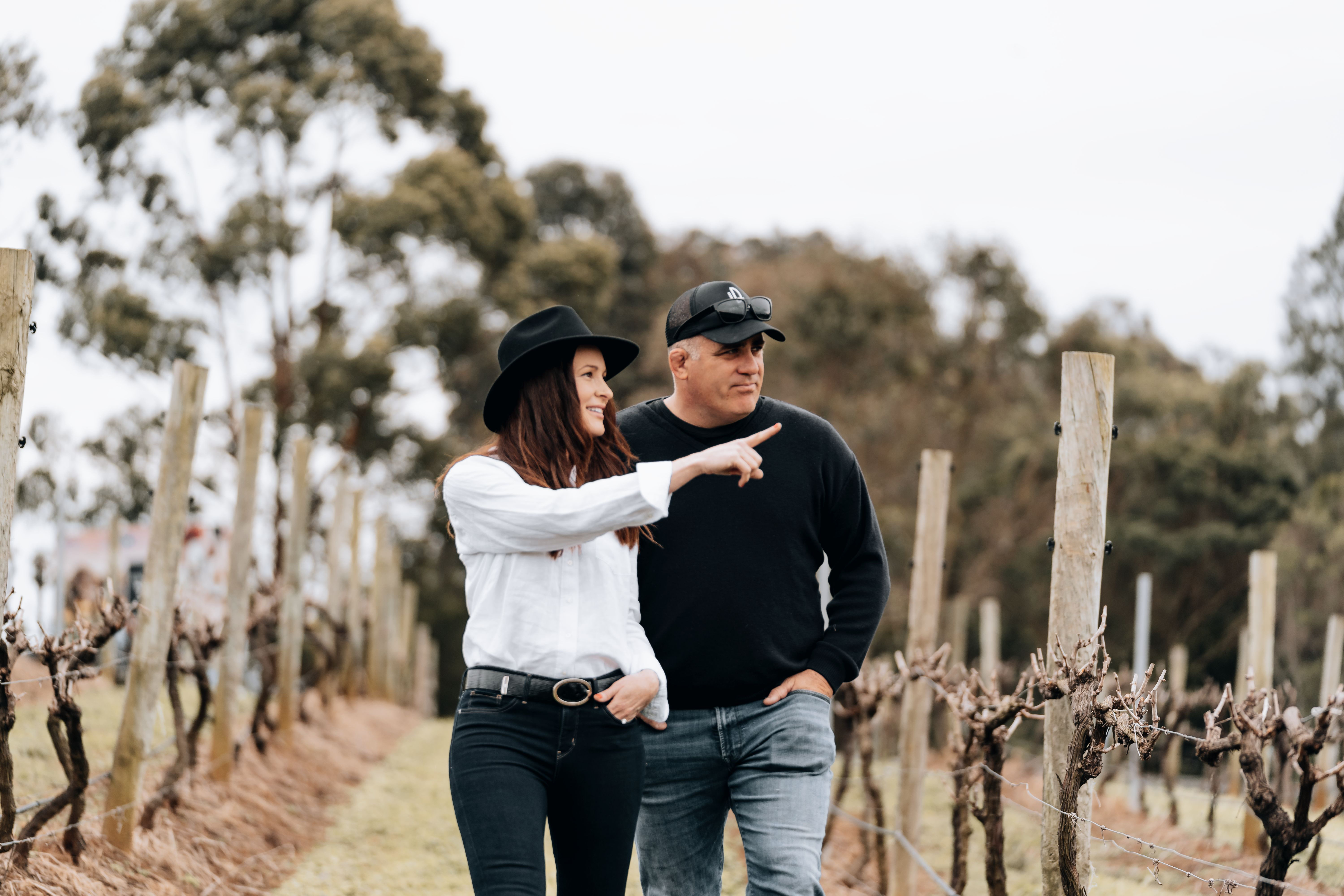 A man and woman walking in the Drury Lane vineyards 